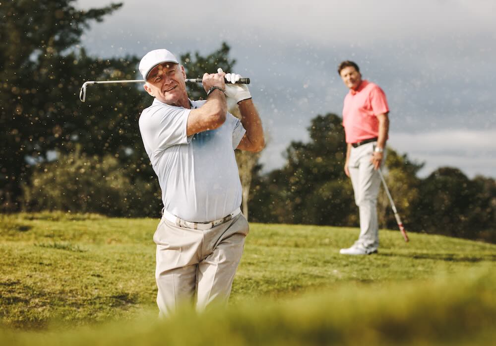 Two senior men playing golf