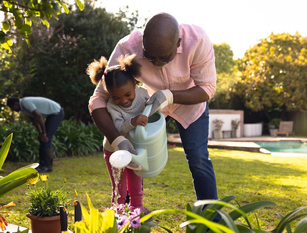 Senior man with his granddaughter gardening 